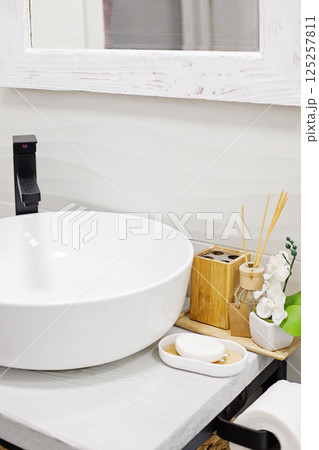 Stylish white sink in modern bathroom interior 125257811