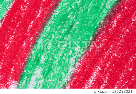Diagonal strokes made with red and green crayons on a white surface, showing the waxy and slightly grainy texture 125258021