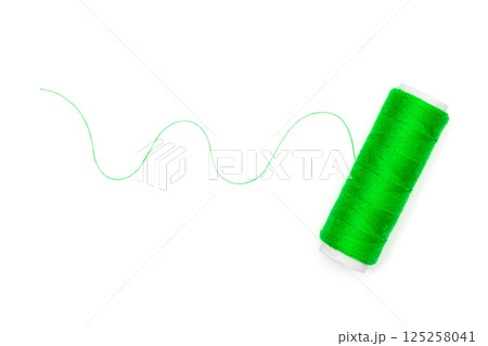 Spool of green thread isolated on a white background Spool of green thread isolated on a white background 125258041