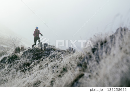 Trail Runner in Misty Mountain Landscape Trail Runner in Misty Mountain Landscape 125258633