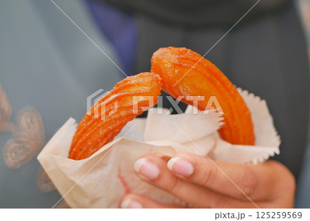 Close-Up of Freshly Prepared Glazed Jalebis In Hands Close-Up of Freshly Prepared Glazed Jalebis In Hands 125259569
