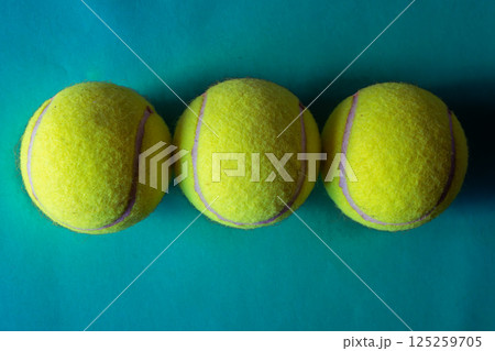 Three tennis balls in green background Top view. Sport concept 125259705