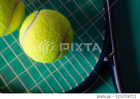 Tennis racket and balls on bright green background, Top view with copy space. 125259711