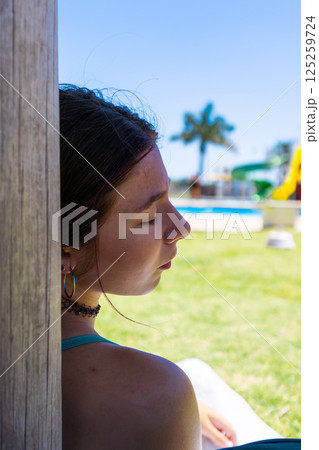 Teenager relaxing in a hotel resort.Travel and holiday concept Teenager relaxing in a hotel resort.Travel and holiday concept 125259724