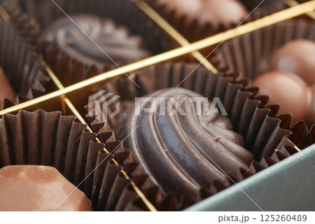 Decadent assortment of handcrafted chocolates in elegant box 125260489