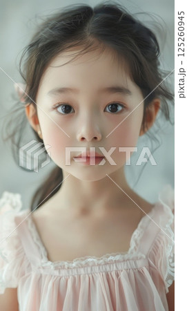 Little beauty girl closeup long hair looking to camera wearing white dress 125260945