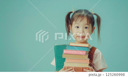 Little girls bring books school activity copy space background 125260998