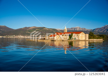 View of Our Lady of Mercy Island from yacht boat near Tivat city in Kotor bay of Adriatic sea in Montenegro in winter time View of Our Lady of Mercy Island from yacht boat near Tivat city in Kotor bay of Adriatic sea in Montenegro in winter time 125263041