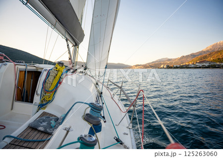 Yacht sailing in Adriatic sea. Close-up view of the deck, mast and sails. Yachting concept 125263060