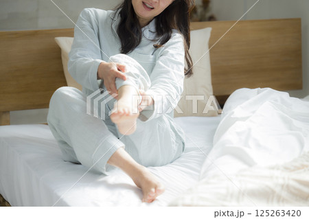 足が攣った寝室のシニア女性　 125263420
