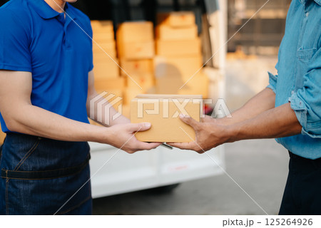 Delivery man by sending box of parcel to customers service at home as having corona virus disease and shipping concept. Delivery man by sending box of parcel to customers service at home as having corona virus disease and shipping concept. 125264926