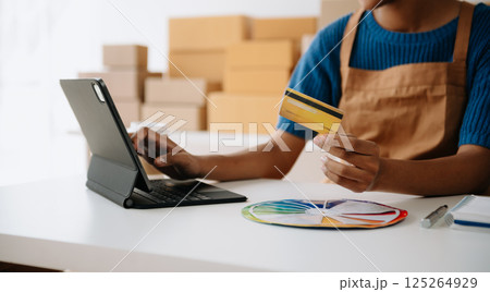 Woman Hand using tablet ,laptop, and holding mobile phone with credit card online banking payment communication network, internet application virtual icon Woman Hand using tablet ,laptop, and holding mobile phone with credit card online banking payment communication network, internet application virtual icon 125264929