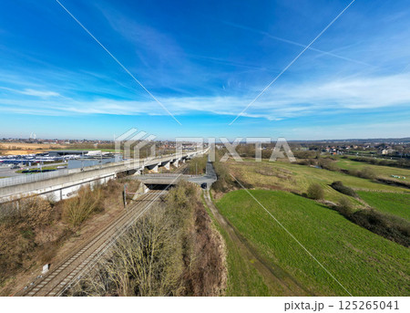 An Aerial Perspective Showcasing Expansive Fields and Railways Beneath an Open, Clear, and Blue Sky An Aerial Perspective Showcasing Expansive Fields and Railways Beneath an Open, Clear, and Blue Sky 125265041