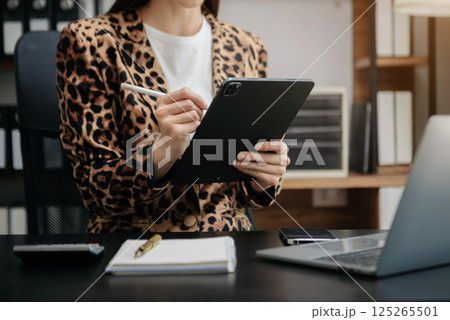 Working Process in Modern Office. Young Woman Account Manager Working at Table with New Business Project. Typing keyboard,Using Contemporary Working Process in Modern Office. Young Woman Account Manager Working at Table with New Business Project. Typing keyboard,Using Contemporary 125265501
