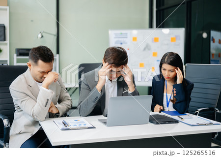 Furious two Asian businesspeople arguing strongly after making a mistake at work in panic after company bankruptcy concept Furious two Asian businesspeople arguing strongly after making a mistake at work in panic after company bankruptcy concept 125265516