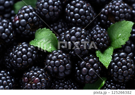 Ai generated Fresh ripe blackberries showing texture and green leaves closeup 125266382