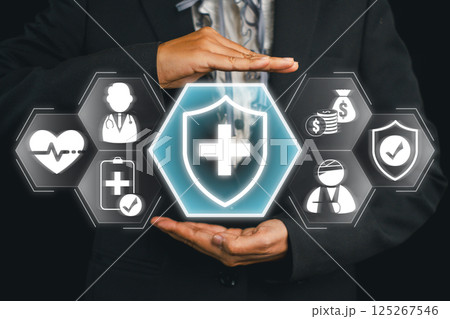 Conceptual image of health insurance with hands shielding medical and financial icons, symbolizing protection and security. 125267546