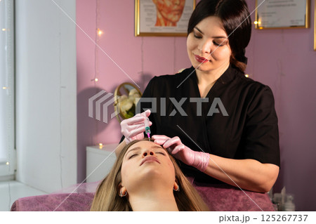 Aesthetician prepares skin for non-surgical facial rejuvenation procedure Aesthetician prepares skin for non-surgical facial rejuvenation procedure 125267737