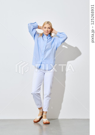 Blonde woman in jeans and button down shirt 125268931