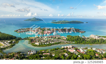 Marina with yachts and boats, surrounded by turquoise waters and islands. Eden island. Seychelles, Mahe. 125268985