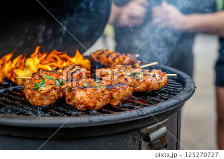 Grilling delicious skewers of marinated meat on web platform creates vibrant atmosphere for streaming culinary delights 125270727