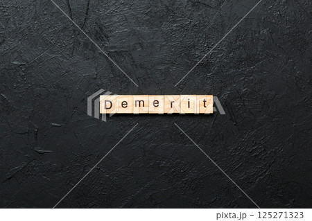demerit word written on wood block. demerit text on table, concept demerit word written on wood block. demerit text on table, concept 125271323