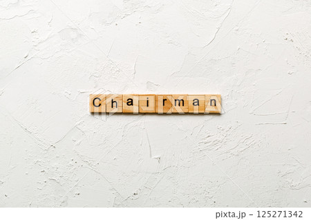 CHAIRMAN word written on wood block. CHAIRMAN text on cement table for your desing, concept 125271342