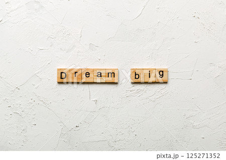 Dream big word written on wood block. Dream big text on cement table for your desing, Top view concept Dream big word written on wood block. Dream big text on cement table for your desing, Top view concept 125271352