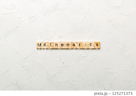 mathematics word written on wood block. mathematics text on cement table for your desing, concept mathematics word written on wood block. mathematics text on cement table for your desing, concept 125271373