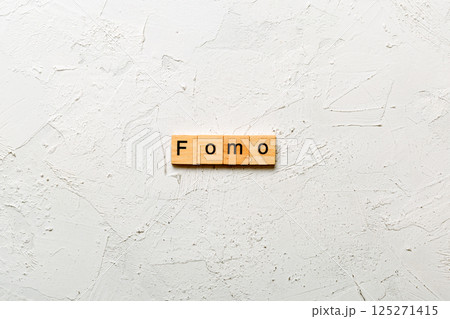 fomo word written on wood block. fomo text on table, concept fomo word written on wood block. fomo text on table, concept 125271415