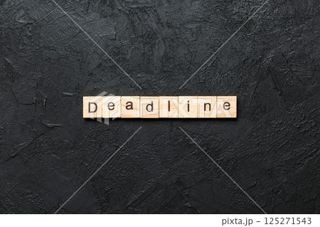 DEADLINE word written on wood block. DEADLINE text on cement table for your desing, concept DEADLINE word written on wood block. DEADLINE text on cement table for your desing, concept 125271543