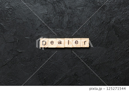Dealer word written on wood block. Dealer text on cement table for your desing, concept 125271544