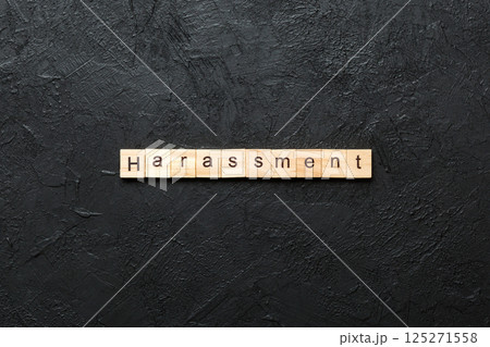 harassment word written on wood block. harassment text on cement table for your desing, concept 125271558