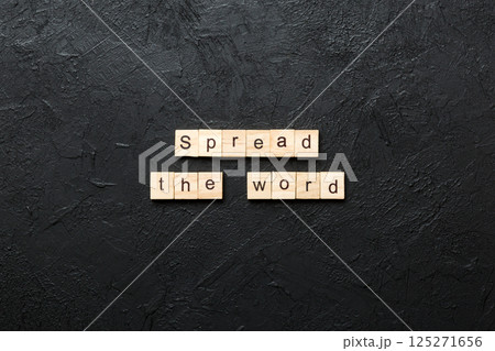 Spread the word word written on wood block. Spread the word text on table, concept 125271656
