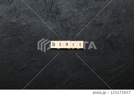 Start word written on wood block. Start text on cement table for your desing, concept 125271657