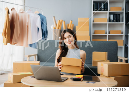 Young woman running online store Startup small business SME, using smartphone or tablet taking receive and checking online purchase shopping Young woman running online store Startup small business SME, using smartphone or tablet taking receive and checking online purchase shopping 125271819