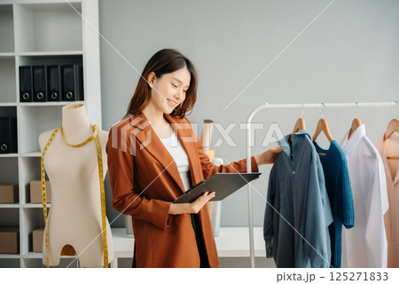 Young woman running online store Startup small business SME, using smartphone or tablet taking receive and checking online purchase shopping order Young woman running online store Startup small business SME, using smartphone or tablet taking receive and checking online purchase shopping order 125271833