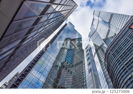 Tall Reflective Office Towers with Glass Facades Captured from Street Level Looking Up Tall Reflective Office Towers with Glass Facades Captured from Street Level Looking Up 125273806