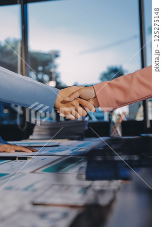 Business success. Business people shaking hands agreement confirmed in the investment business. 125275148