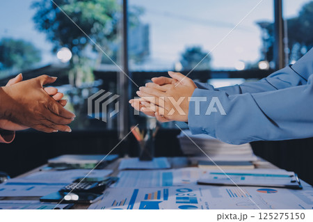 Team of businesspeople clapping hands while having a conference. Business professionals applauding at a seminar. Team of businesspeople clapping hands while having a conference. Business professionals applauding at a seminar. 125275150
