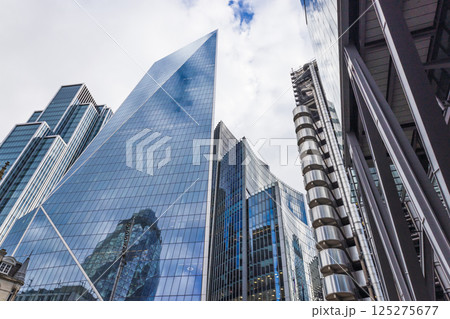 Upward View of Modern Glass Skyscrapers Reflecting in Vibrant Urban Cityscape Upward View of Modern Glass Skyscrapers Reflecting in Vibrant Urban Cityscape 125275677