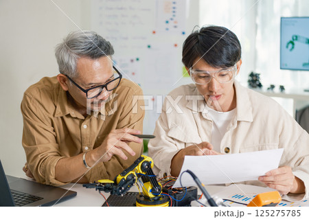 engineering robot technology with asian programmer innovation and research teamwork in coding development engineering robot technology with asian programmer innovation and research teamwork in coding development 125275785