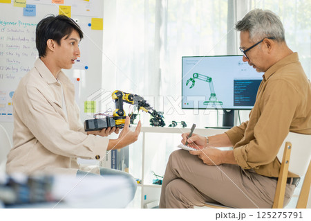 engineering robot technology with asian programmer innovation and research teamwork in coding development 125275791
