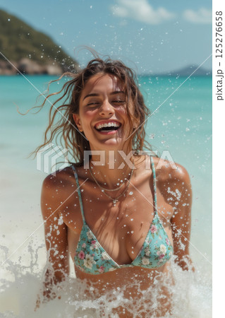 portrait of young beautiful girl wearing bikini swimsuit and posing on resort beach with view of sea and bright sky 125276658
