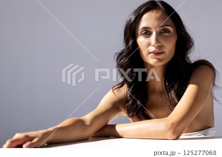 studio portrait of an attractive young woman on a gray background studio portrait of an attractive young woman on a gray background 125277068