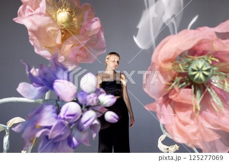 Beautiful woman wearing top on floral background Beautiful woman wearing top on floral background 125277069