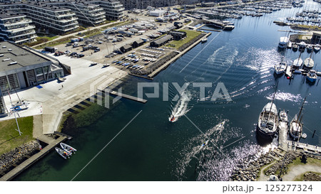 A pleasure craft is sailing out of Aarhus marina and the sailsport area A pleasure craft is sailing out of Aarhus marina and the sailsport area 125277324