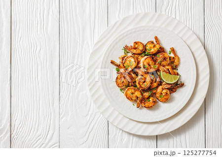 Grilled shrimp on a white plate with lime Grilled shrimp on a white plate with lime 125277754