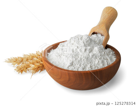 wheat flour in wooden bowl and scoop inserted on top ears near isolated on white background 125278314
