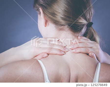 Woman suffering from neck pain 125278649